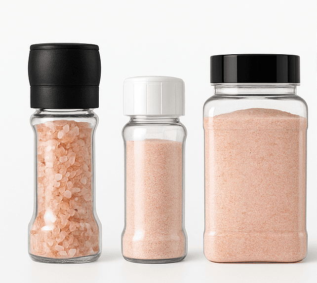 Retail trio: a black-cap grinder for coarse salt, a white-cap shaker for fine salt, and a clear PET jar of fine pink salt.